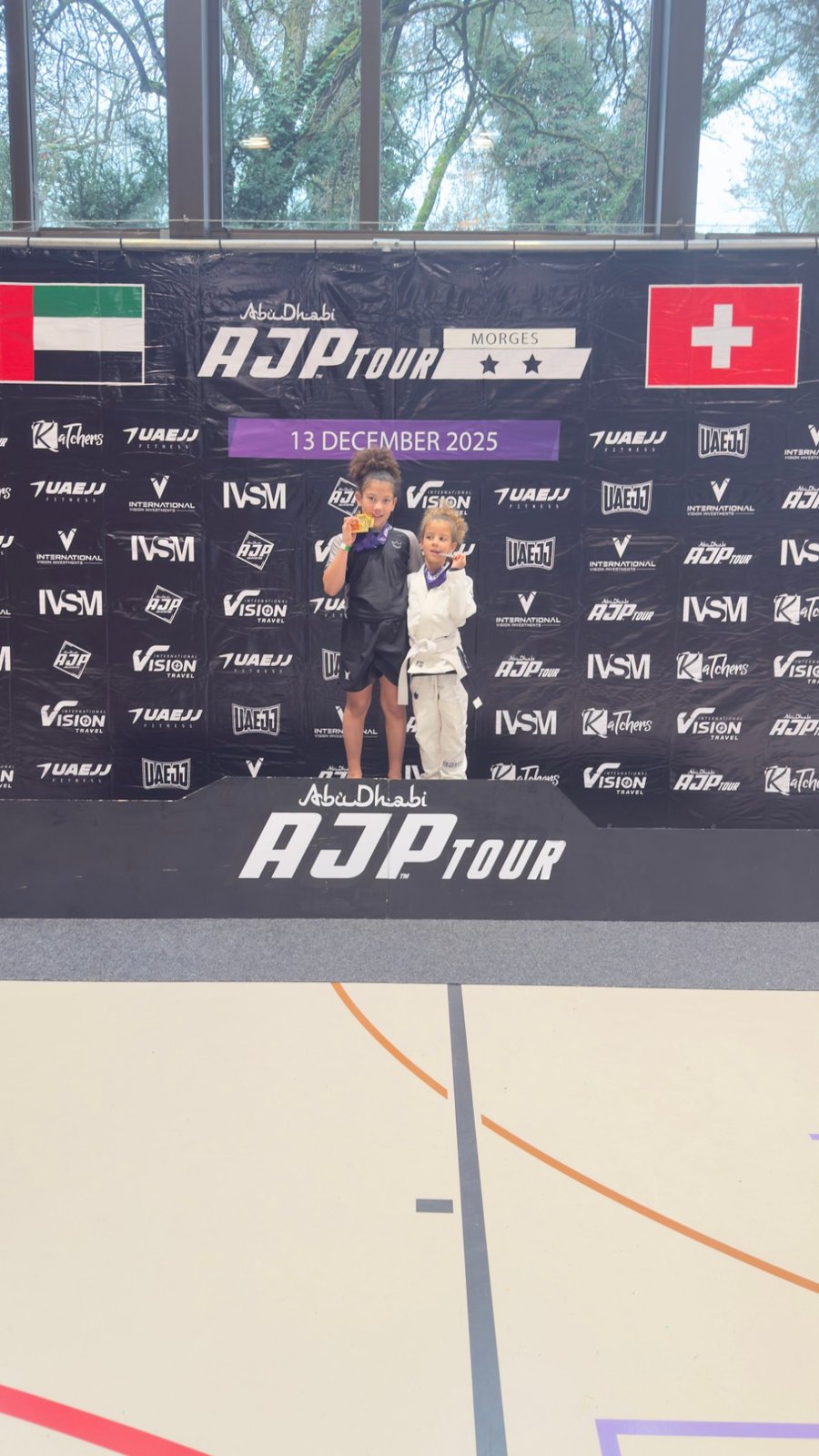 Aleyna and her sister on the Abu Dhabi AJP Tour podium in Morges, December 2025.