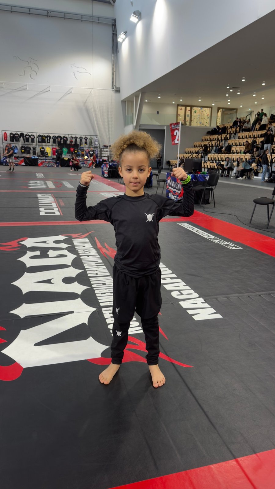 Aleyna flexing on the mats at NAGA Paris, March 2026.